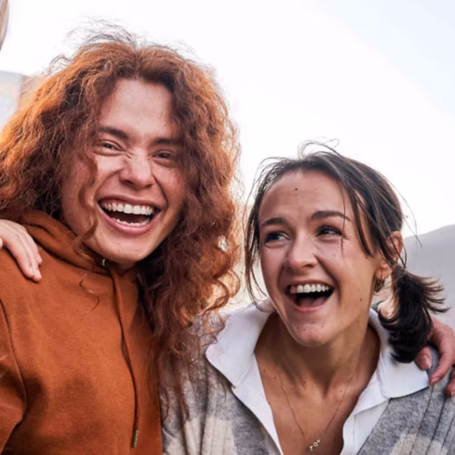 Group of friends laughing leaning on each other