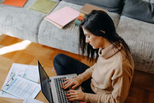 Person on computer taking notes