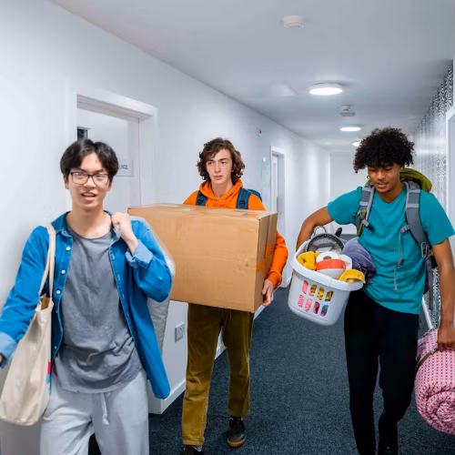 Three people moving into dorms