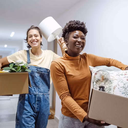 Two friends moving belongings into dorm