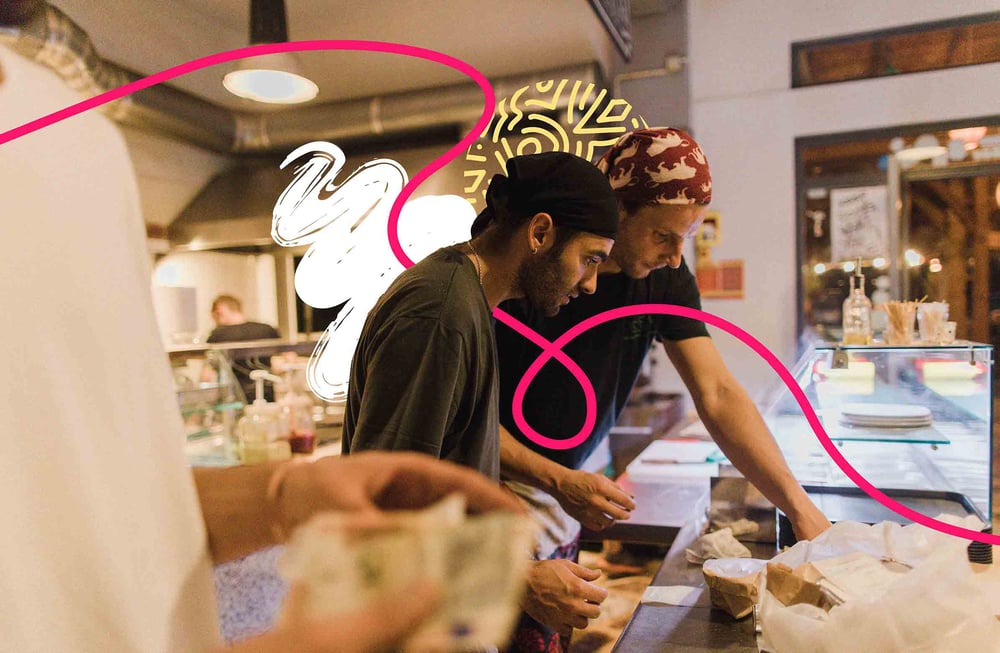 Two people cooking together in a kitchen