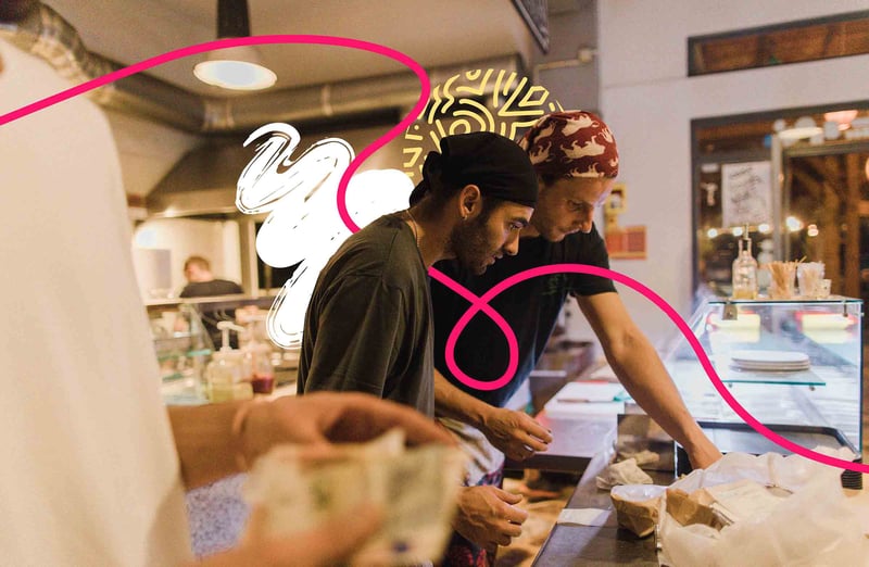 Two people cooking together in a kitchen