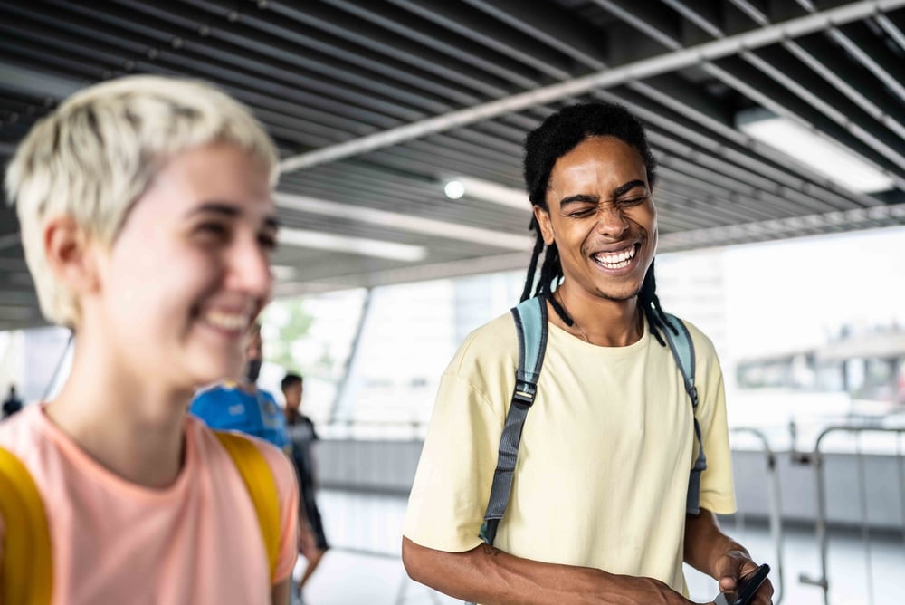 Two people walking and laughing