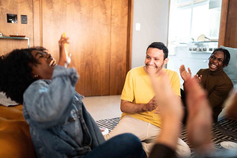 Group of people sitting around and laughing