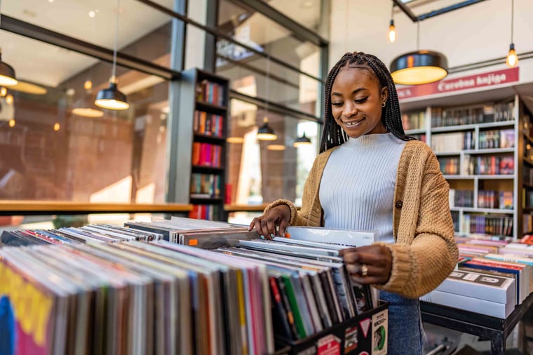Person browsing through vinyl records