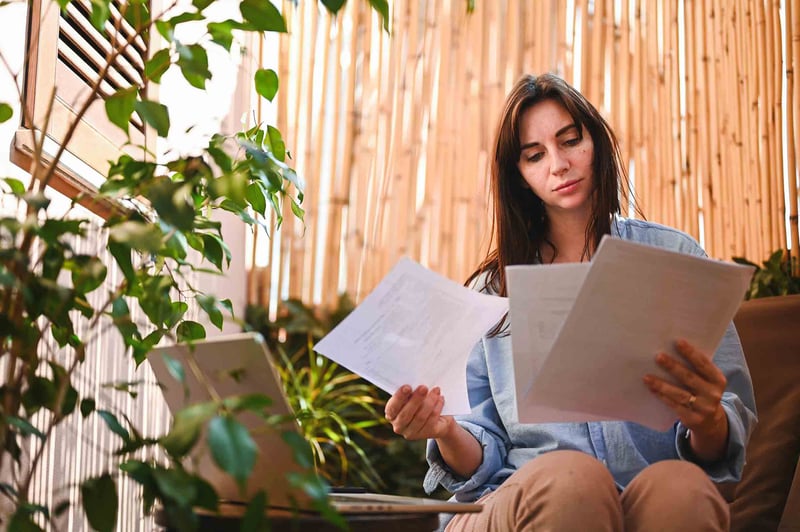person reviewing papers while sitting outside
