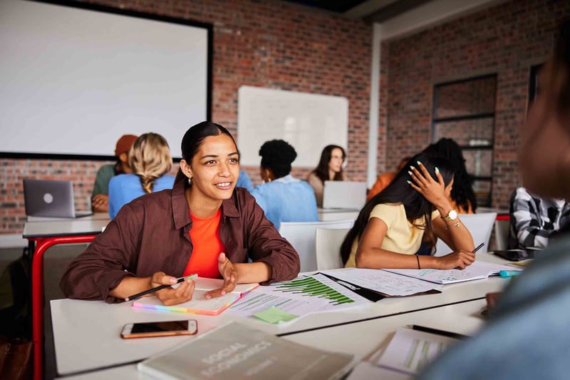 People taking notes in a classroom