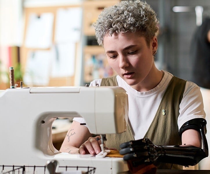 Person stitching on sewing machine