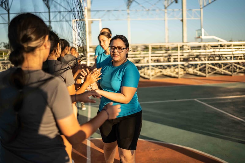 People congratulating each other after volleyball game