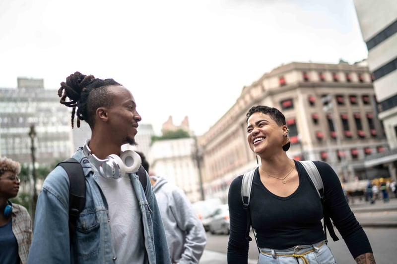 Two friends laughing and walking