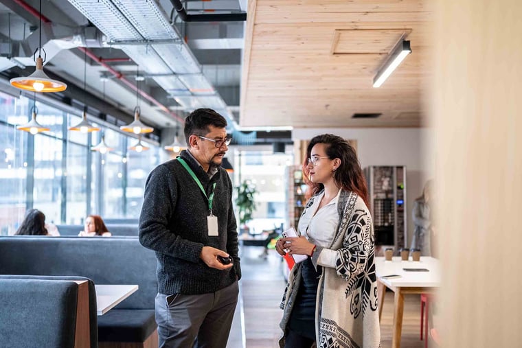 Intern speaking with office worker