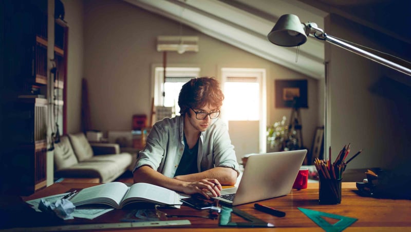 Person working at desk on laptop