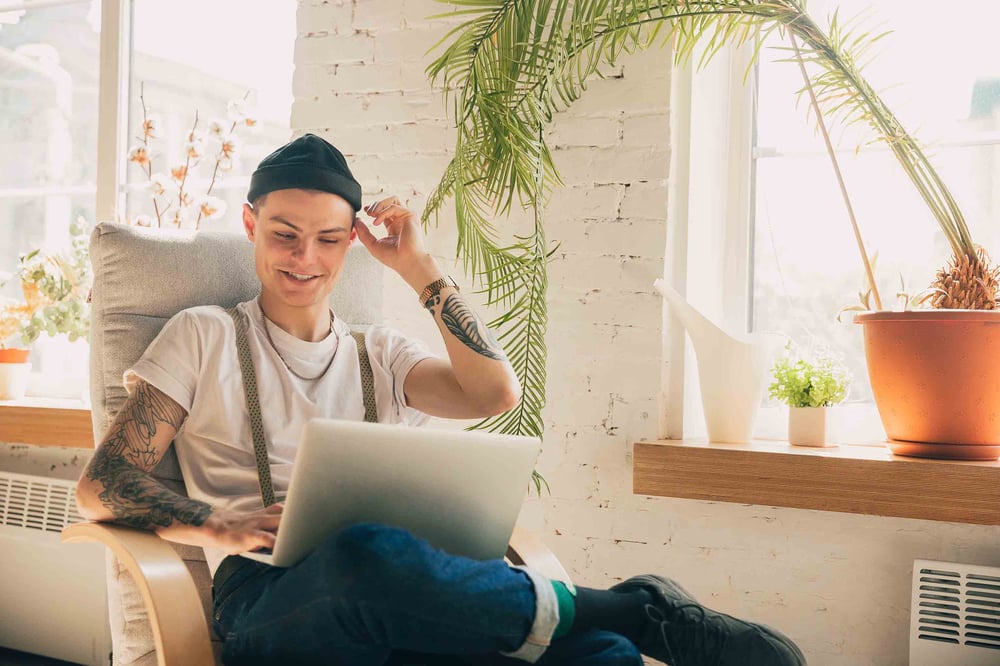 Person smiling on laptop computer