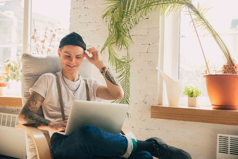 Person smiling on laptop computer